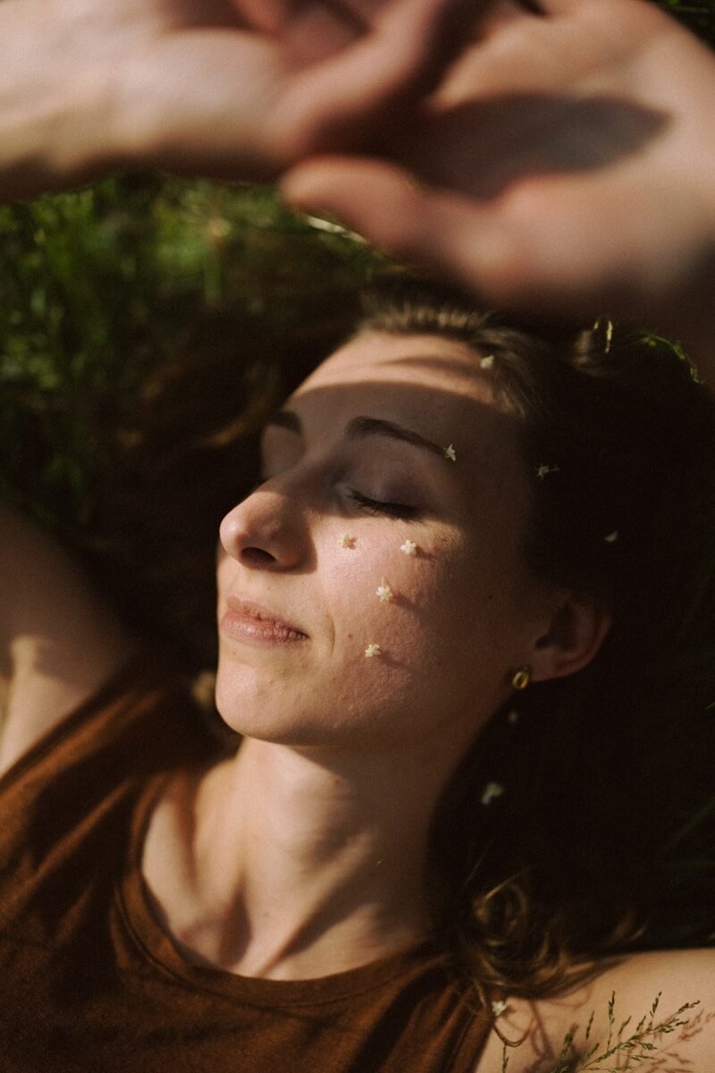 Woman relaxes outdoors with floral accents.